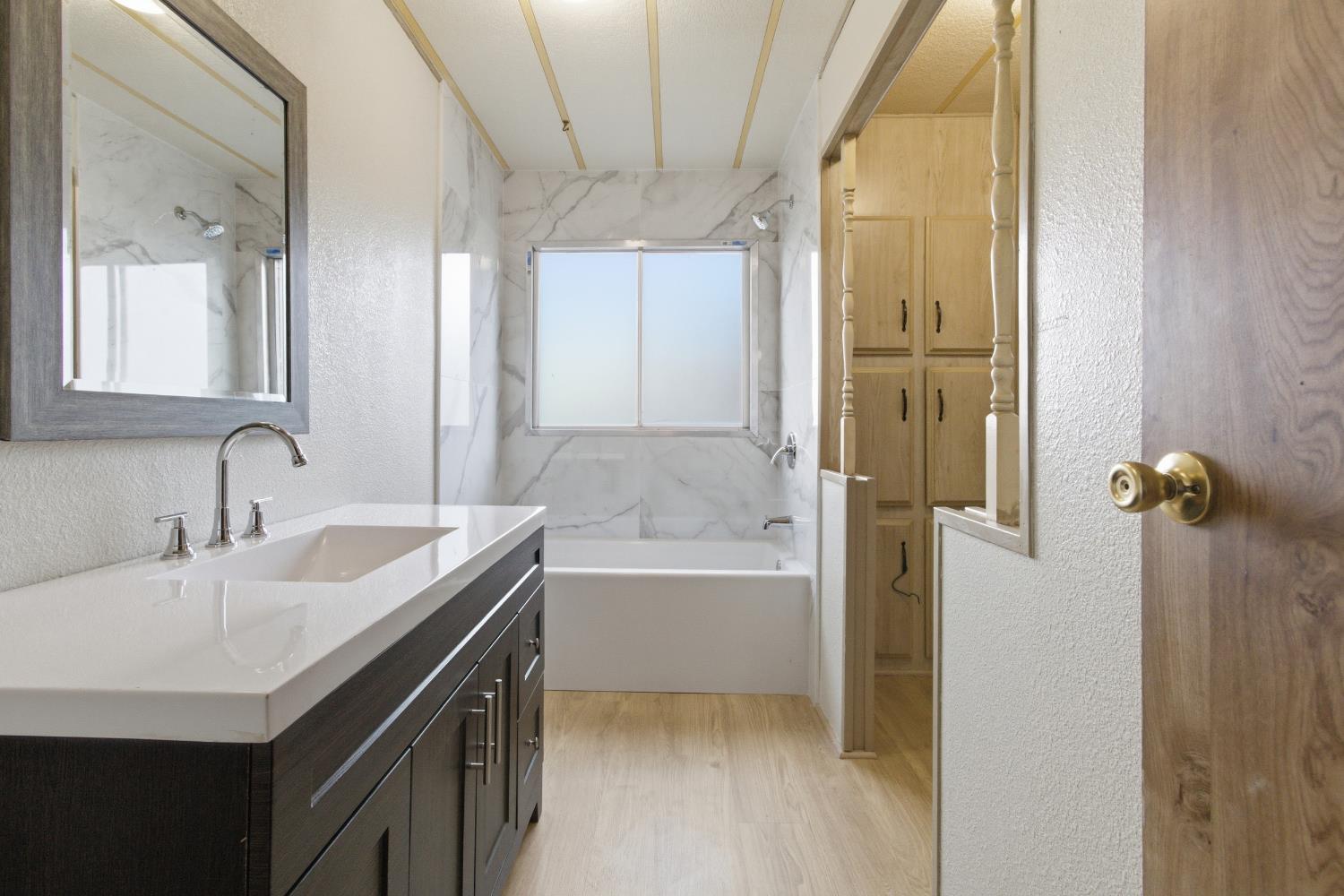 4117 El Dorado Road Placerville, CA 95667 - Photo 48 of 54 a bathroom with a granite countertop sink a toilet and shower