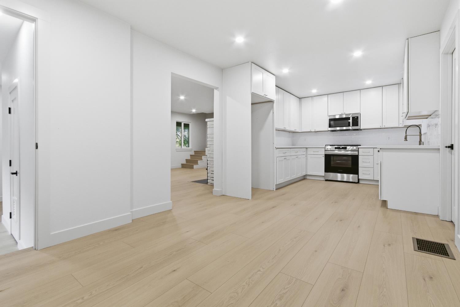 4117 El Dorado Road Placerville, CA 95667 - Photo 9 of 54 a view of a kitchen with a sink and dishwasher a refrigerator with white cabinets