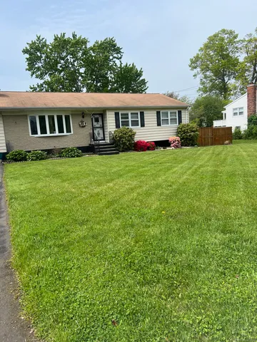 a front view of a house with a yard