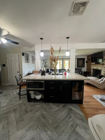 a living room with stainless steel appliances kitchen island granite countertop furniture and a kitchen view