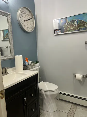 a bathroom with a toilet a sink and mirror