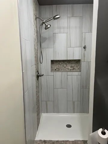 a bathroom with a bathtub and shower