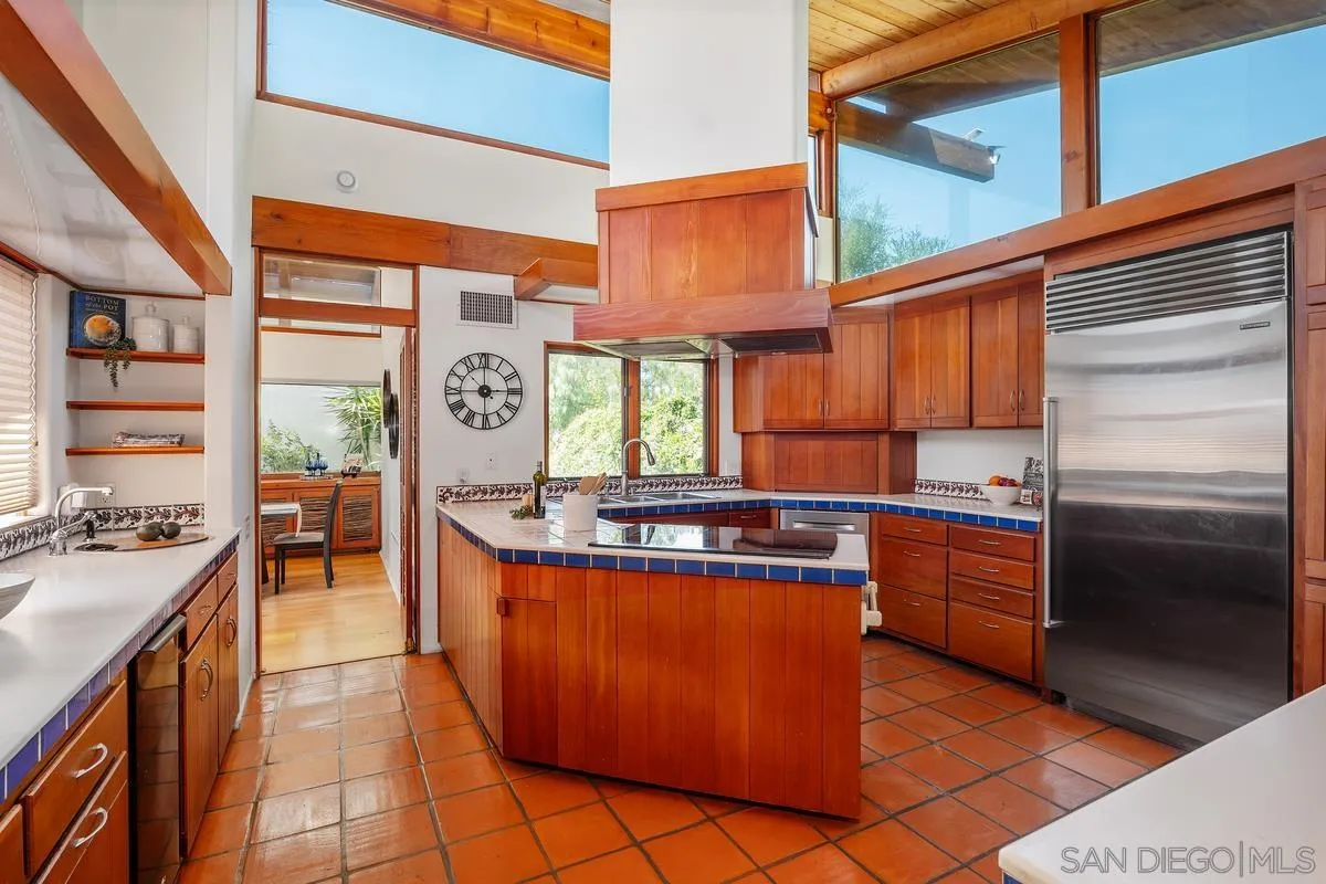 13622 Orchard Gate Road Poway, CA 92064 - Photo 20 of 40 a kitchen with stainless steel appliances granite countertop a stove a sink and a refrigerator