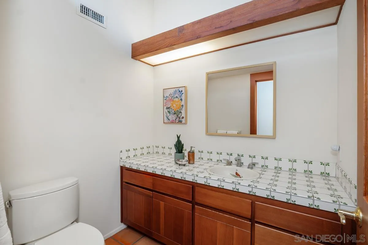 13622 Orchard Gate Road Poway, CA 92064 - Photo 34 of 40 a bathroom with a granite countertop sink and a mirror