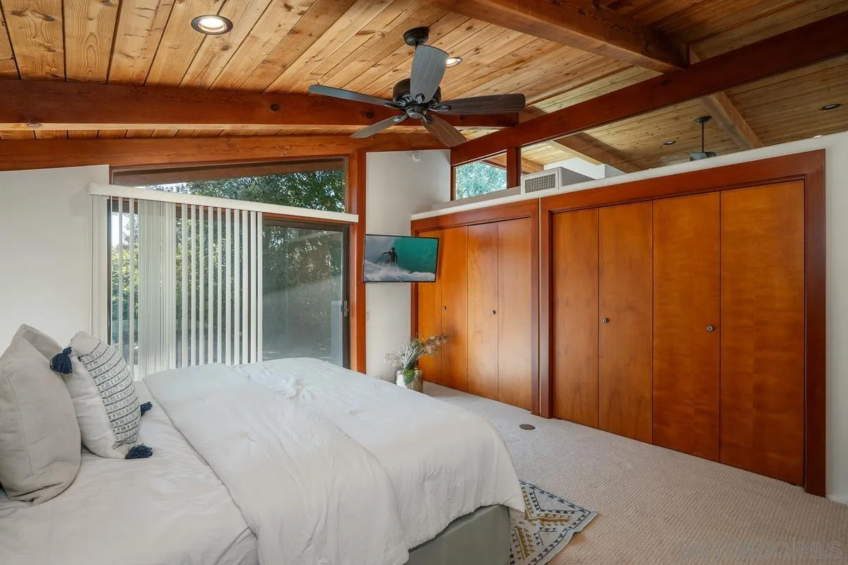 13622 Orchard Gate Road Poway, CA 92064 - Photo 38 of 40 a bedroom with a bed and a chandelier