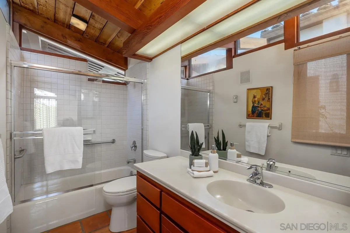 13622 Orchard Gate Road Poway, CA 92064 - Photo 39 of 40 a bathroom with a sink toilet vanity and shower