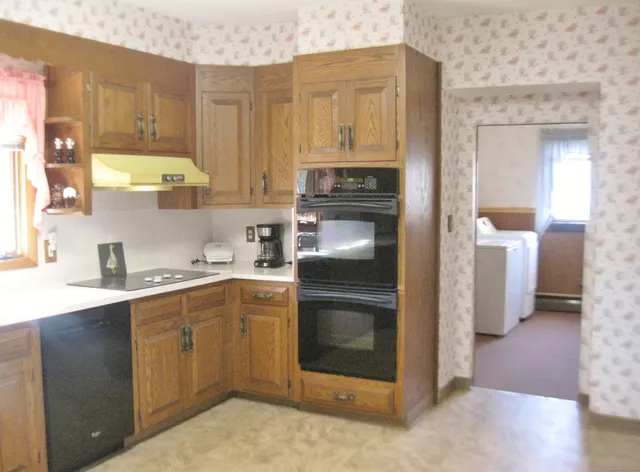 a kitchen with a refrigerator sink and cabinets