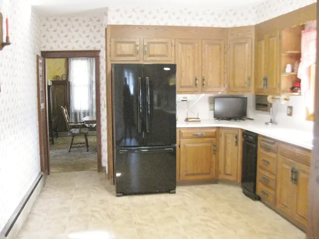 a kitchen with a sink window and cabinets
