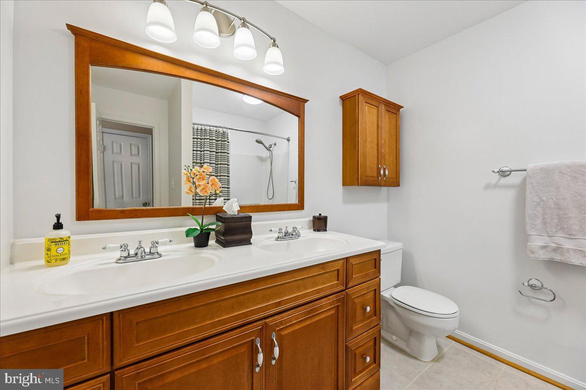 5211 Spring Branch Boulevard Dumfries, VA 22025 - Photo 13 of 32 a bathroom with a toilet sink and mirror