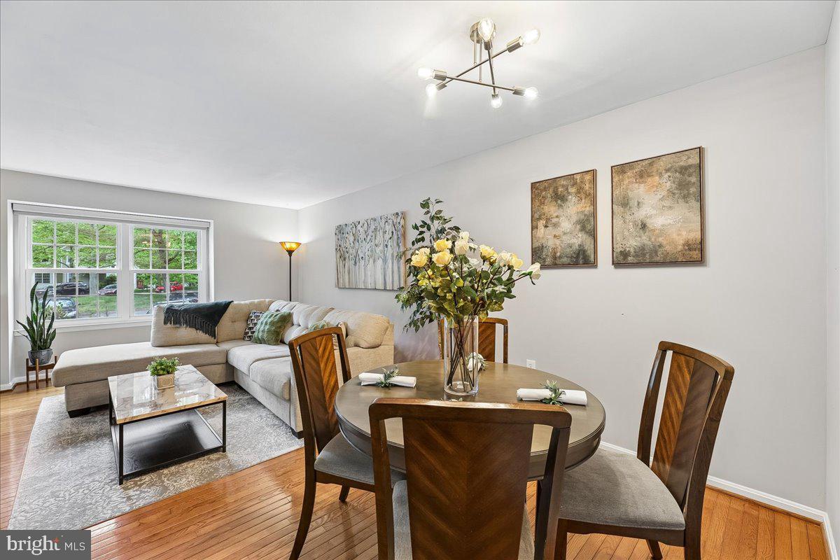 5211 Spring Branch Boulevard Dumfries, VA 22025 - Photo 5 of 32 a dining room with furniture a potted plant and a chandelier