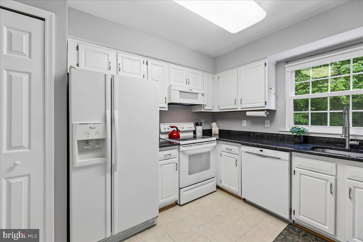 5211 Spring Branch Boulevard Dumfries, VA 22025 - Photo 6 of 32 a white refrigerator freezer sitting inside of a kitchen