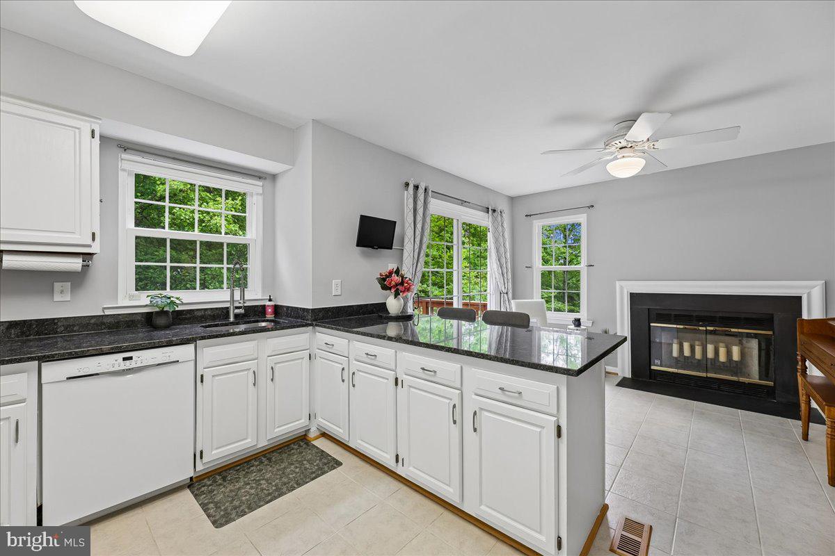 5211 Spring Branch Boulevard Dumfries, VA 22025 - Photo 7 of 32 a kitchen with granite countertop a sink cabinets and window