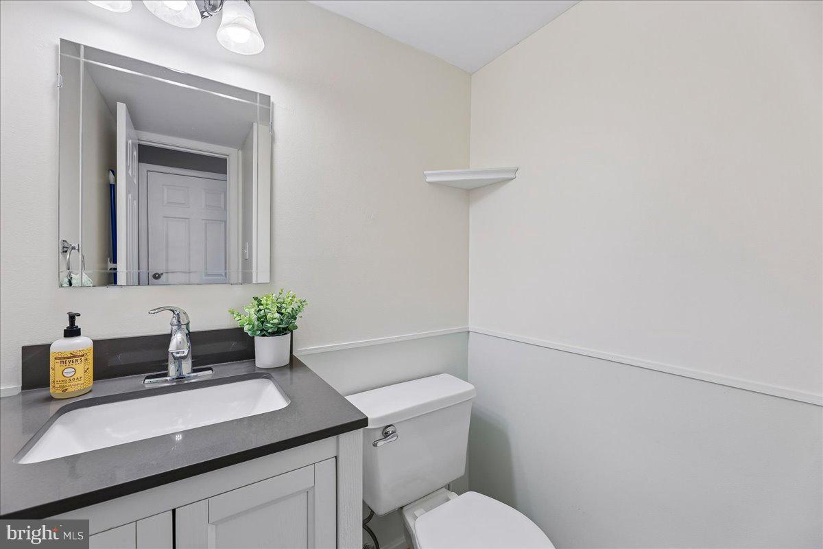 5211 Spring Branch Boulevard Dumfries, VA 22025 - Photo 10 of 32 a bathroom with a sink a toilet and mirror