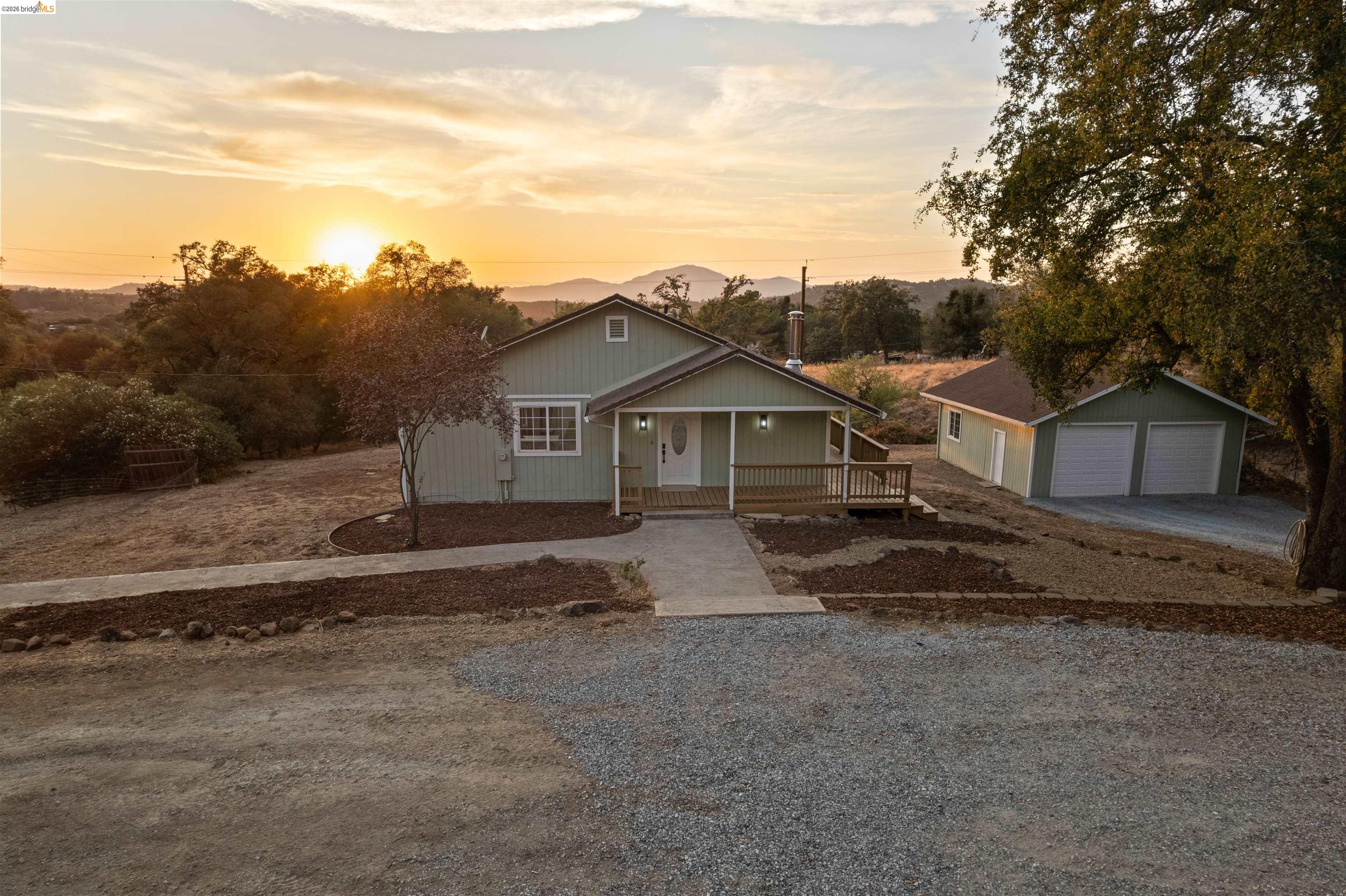 19676 Rawhide Road Sonora, CA 95370 - Photo 64 of 67 Single-story residence with a covered porch, wood decking, and light green exterior siding