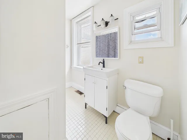 a balcony with wooden floor and outdoor seating