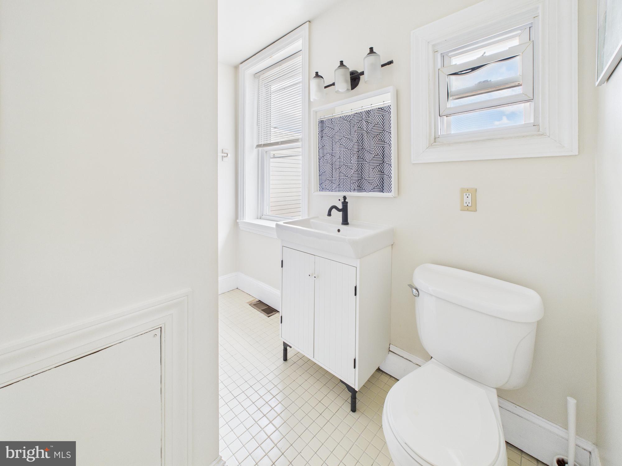 3829 Hamilton Street, Unit C Philadelphia, PA 19104 - Photo 16 of 17 a white toilet sitting next to a bathroom sink