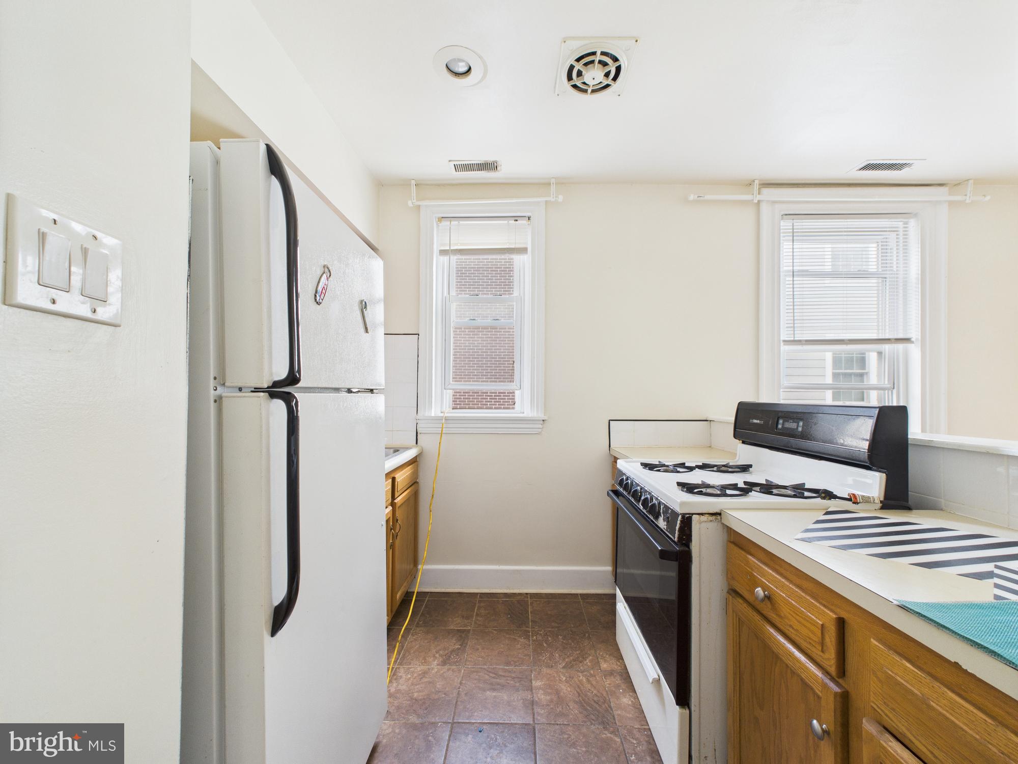 3829 Hamilton Street, Unit C Philadelphia, PA 19104 - Photo 2 of 17 a kitchen with stainless steel appliances granite countertop a refrigerator and a stove
