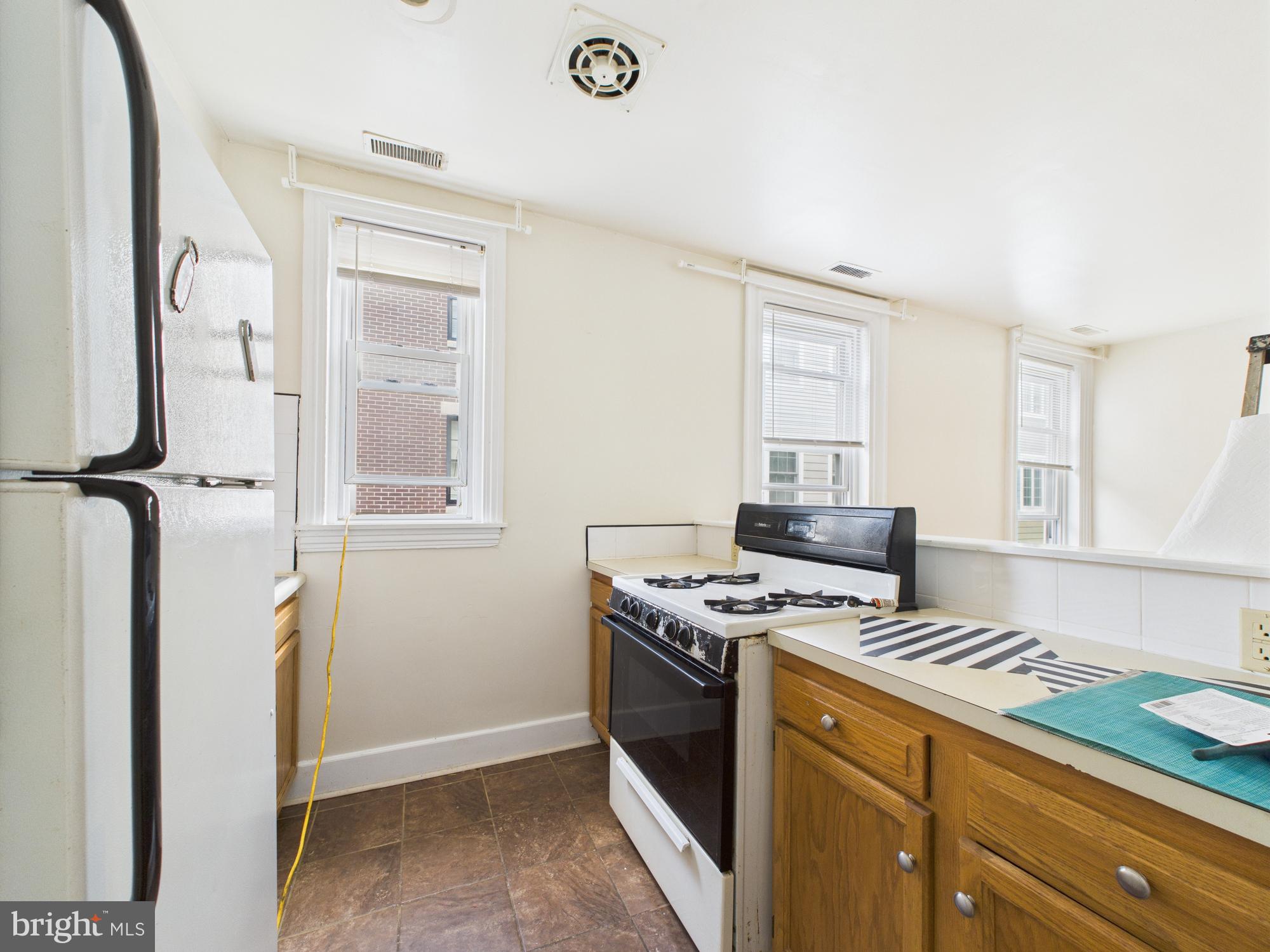 3829 Hamilton Street, Unit C Philadelphia, PA 19104 - Photo 3 of 17 a kitchen with a stove and a microwave