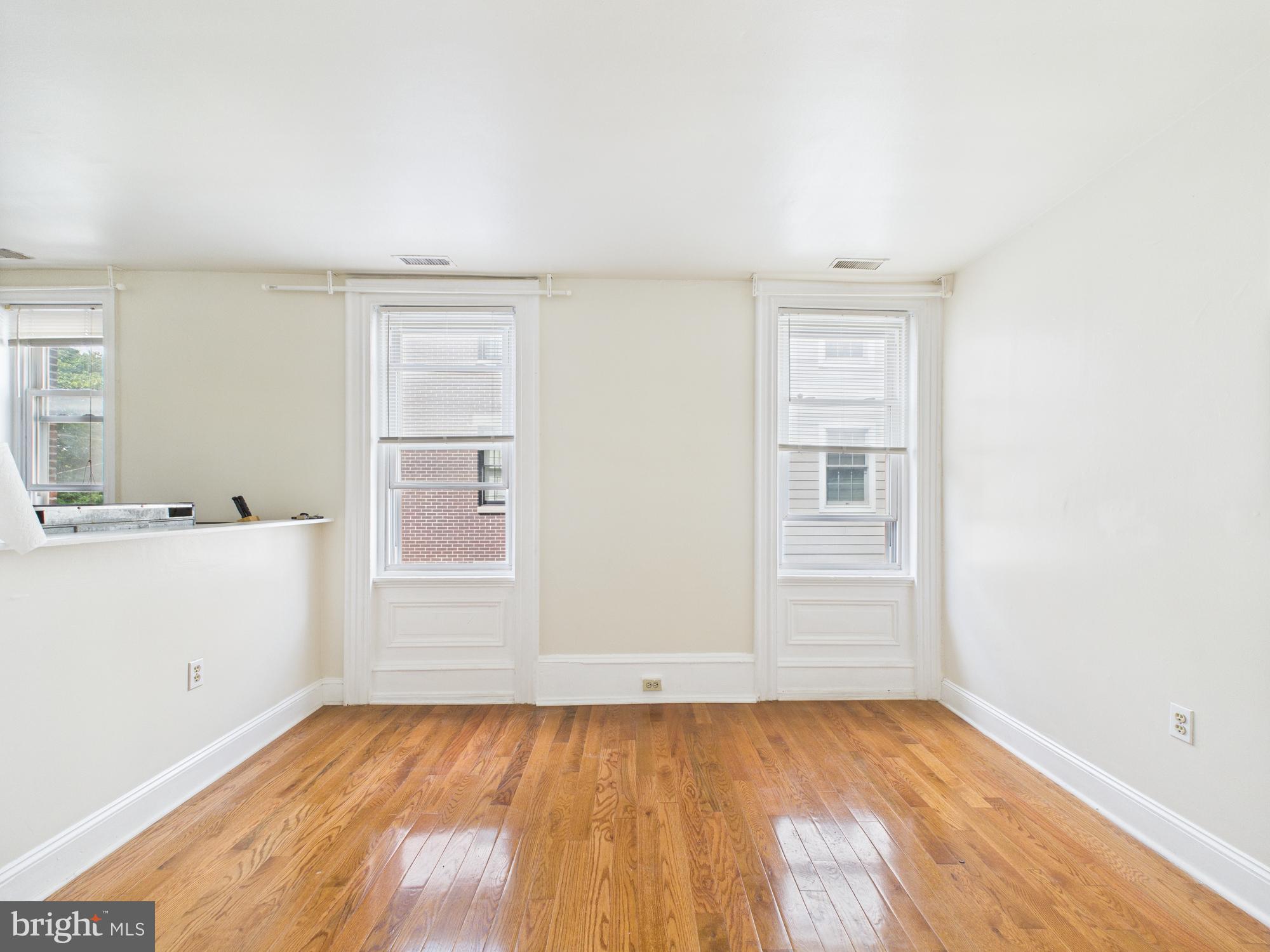 3829 Hamilton Street, Unit C Philadelphia, PA 19104 - Photo 5 of 17 an empty room with wooden floor and windows