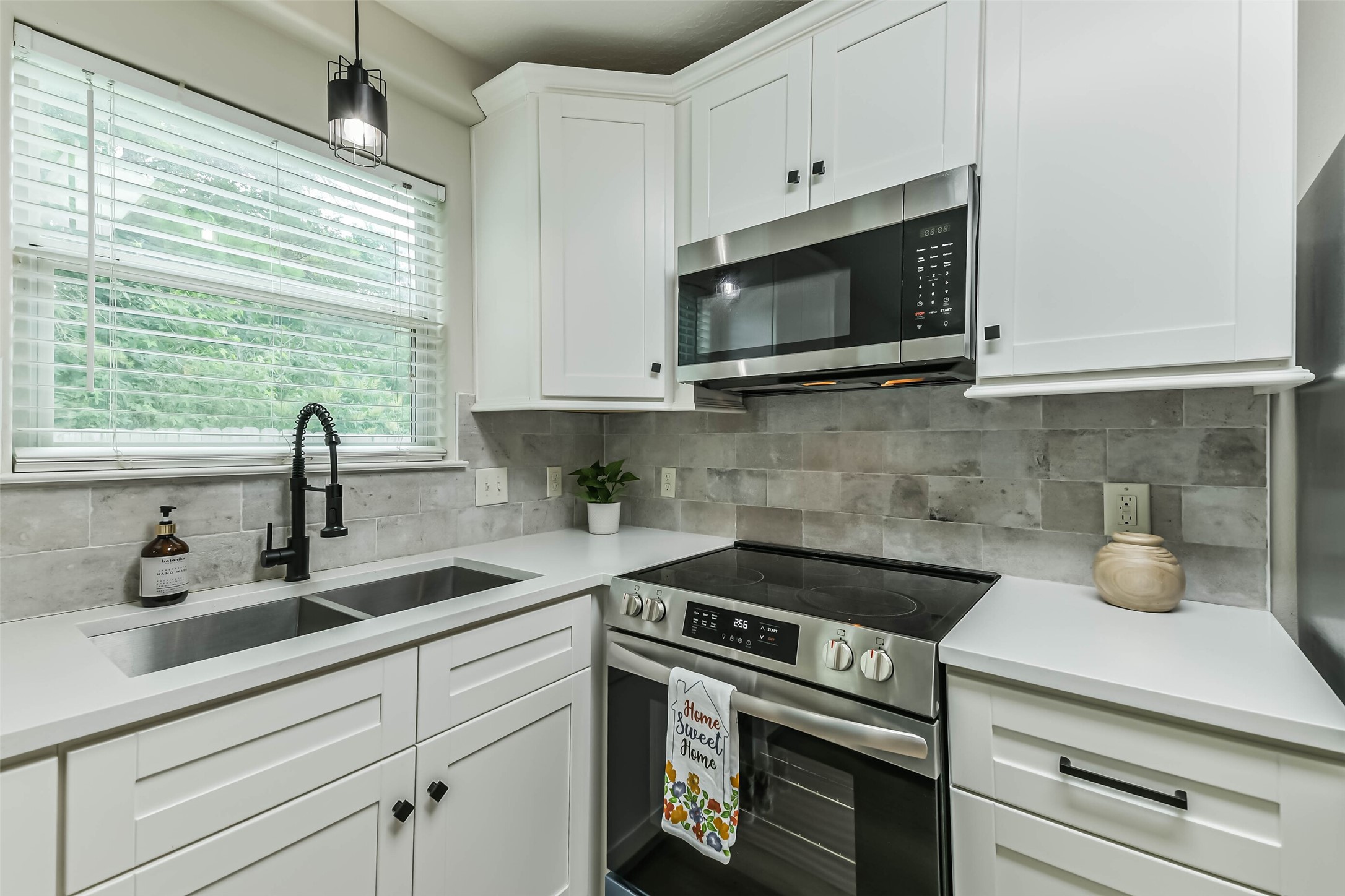 1799 League Line Road, Unit 1 Conroe, TX 77304 - Photo 8 of 32 This kitchen is gorgeous with stainless appliances, tile backsplash, upgraded sink, and pendant lighting.