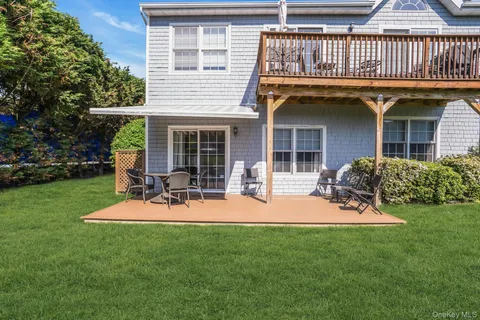 a view of a backyard with sitting area and garden