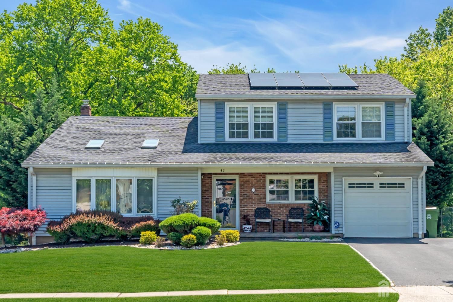 42 Ridge Road Edison, NJ 08817 - Photo 1 of 47 front view of a house with a yard