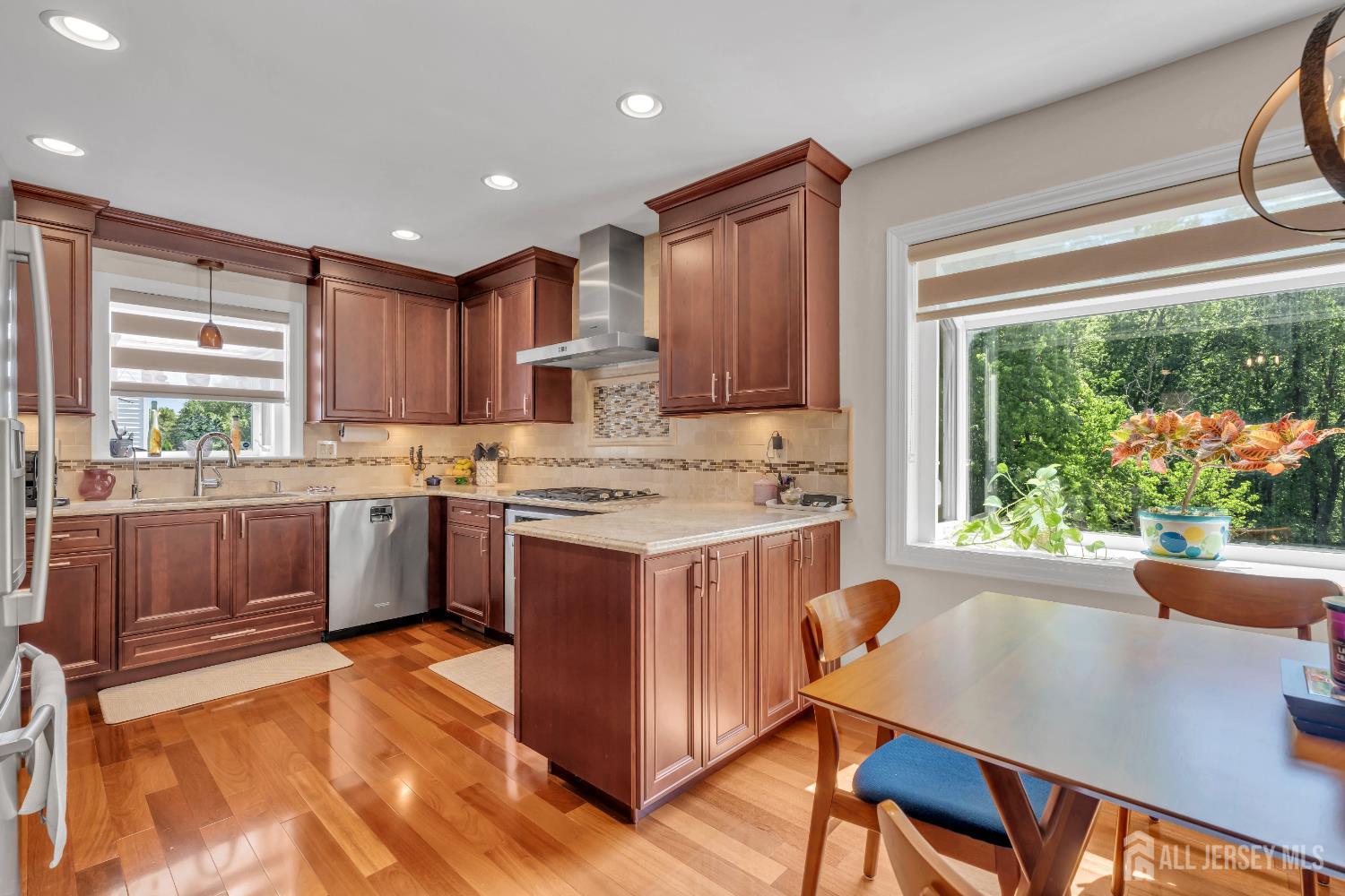 42 Ridge Road Edison, NJ 08817 - Photo 17 of 47 a kitchen with kitchen island a stove a sink a window and cabinets