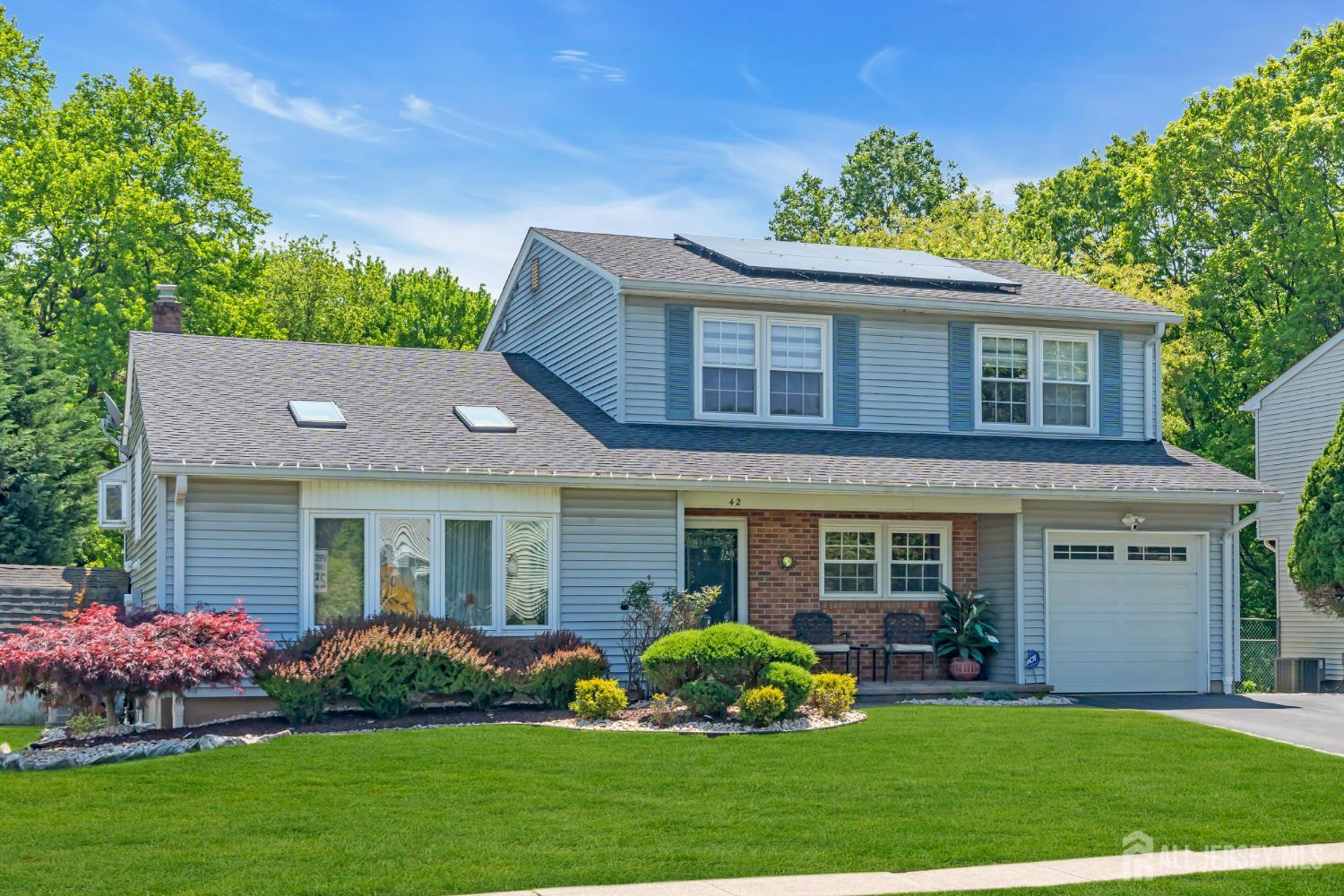 42 Ridge Road Edison, NJ 08817 - Photo 2 of 47 a front view of a house with a garden and plants
