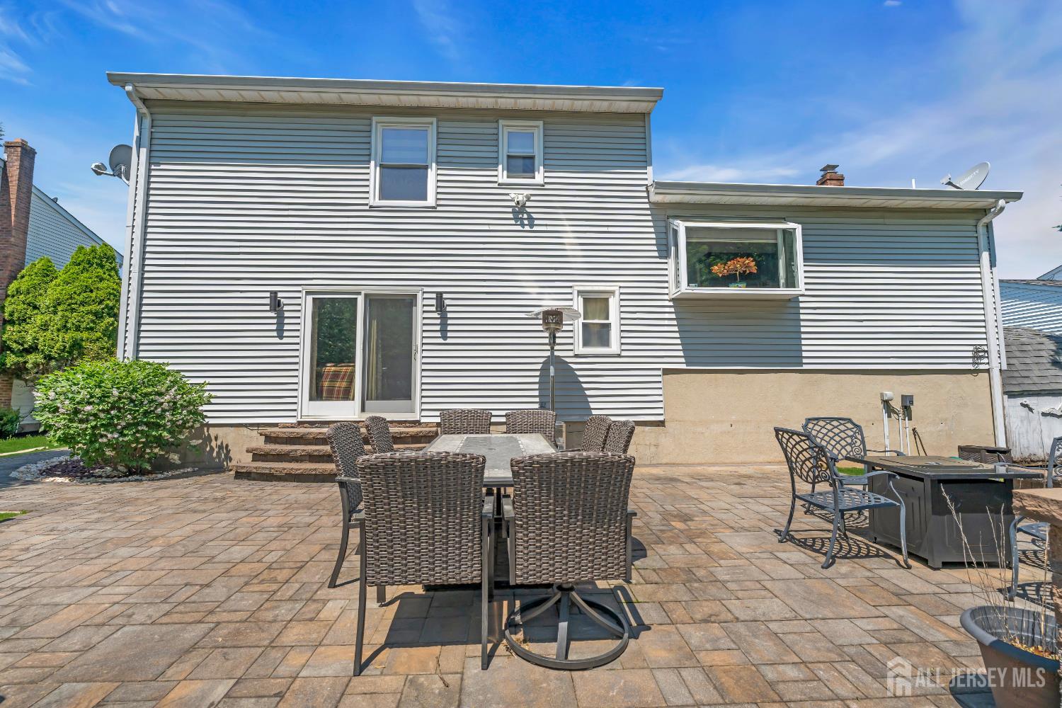 42 Ridge Road Edison, NJ 08817 - Photo 37 of 47 a view of a patio with table and chairs and potted plants