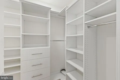 a hallway with cabinets and wooden floor