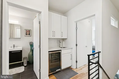 a bedroom with bed and wooden floor