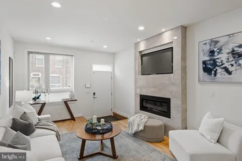 a living room with furniture and a wooden floor