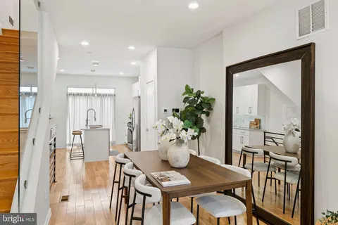 a kitchen with stainless steel appliances granite countertop a sink a refrigerator and a stove