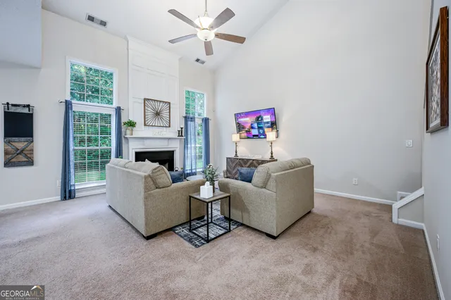 a living room with furniture and a fireplace