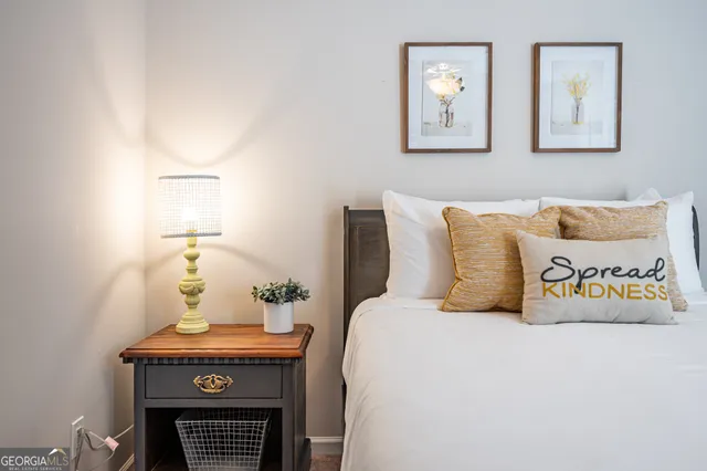 a bedroom with a bed and paintings on the wall