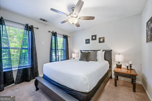 a large bed sitting in a bedroom next to a window