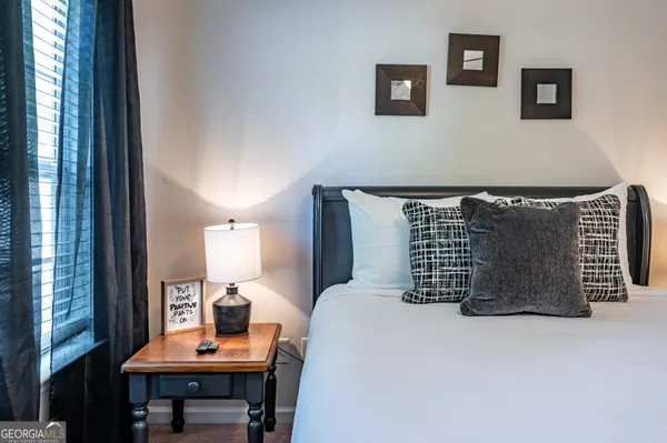 a bedroom with a bed and a table in it