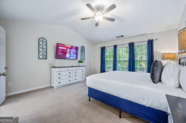 a bedroom with a large bed and a window