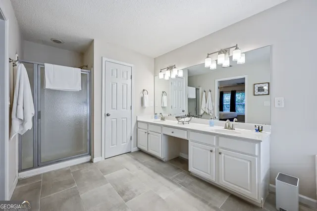 a large bathroom with a double vanity sink mirror and shower