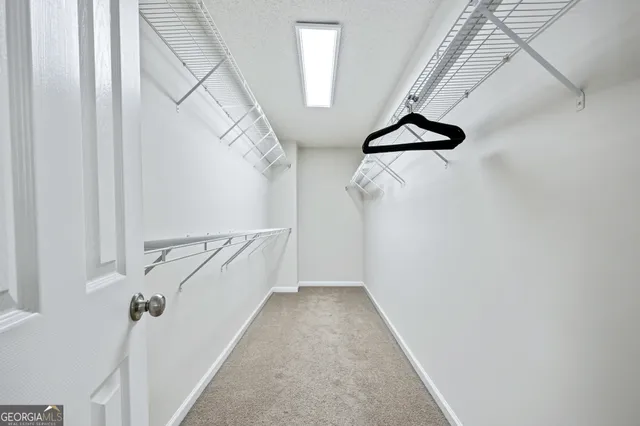 a view of a hallway with a white walls and stairs