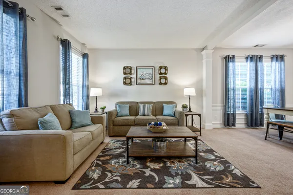 a living room with furniture and a rug