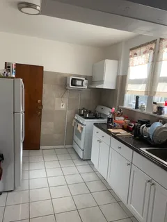 a kitchen with a sink a refrigerator and cabinets