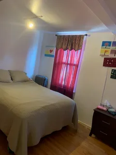 a bedroom with a bed and window