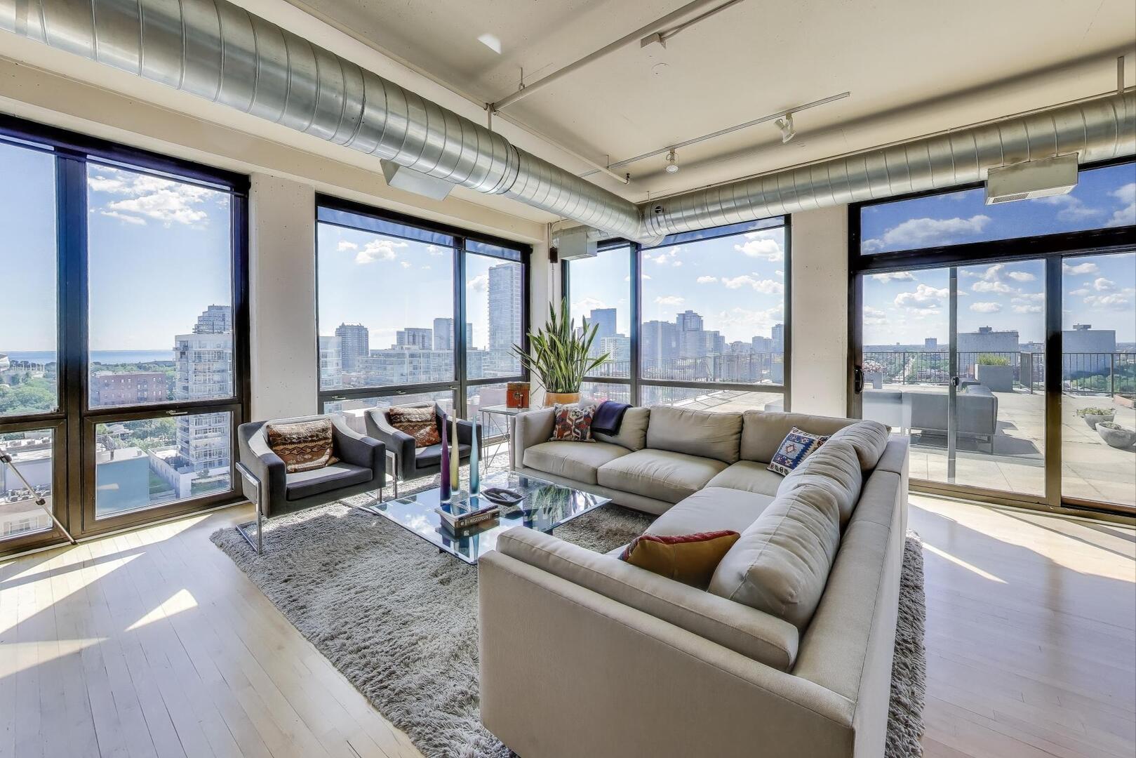 1530 South State Street, Unit 12J Chicago, IL 60605 - Photo 5 of 28 a living room with furniture and floor to ceiling windows