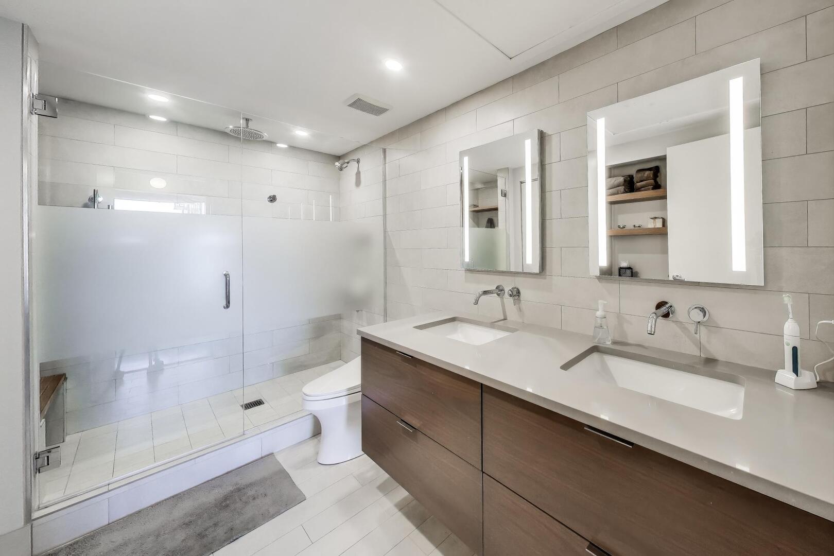 1530 South State Street, Unit 12J Chicago, IL 60605 - Photo 10 of 28 a bathroom with a double vanity sink toilet mirror and shower