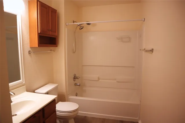 an empty room with wooden floor and closet