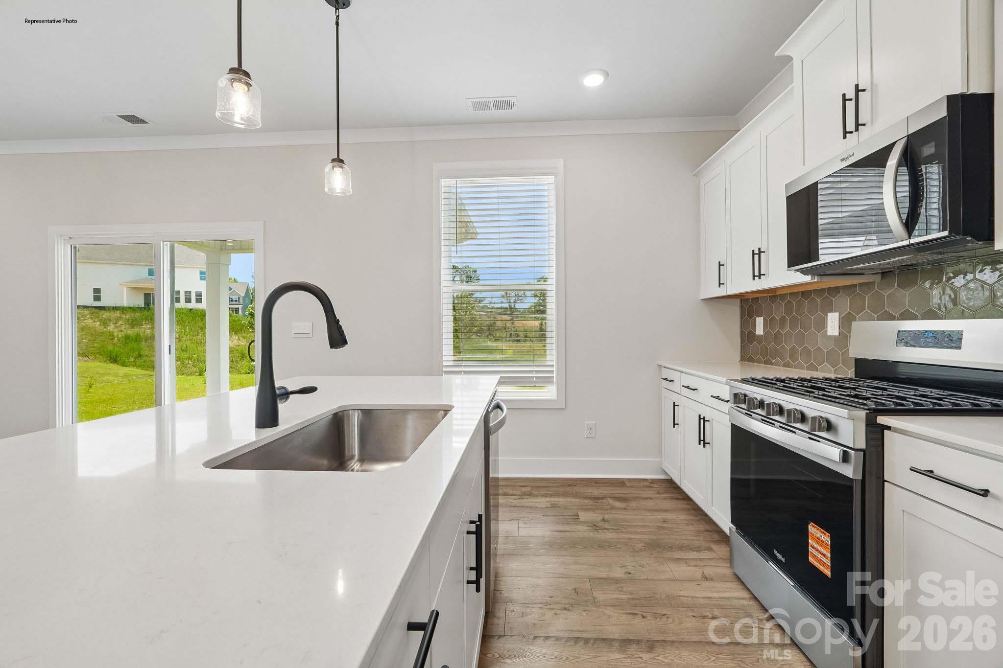 541 Mahogany Road York, SC 29745 - Photo 13 of 32 a kitchen with a stove a sink and a microwave