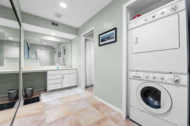 a bathroom with a sink a toilet and a large mirror