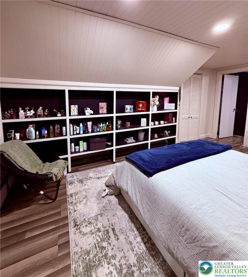 1275 Macada Road Bethlehem, PA 18017 - Photo 63 of 87 Built-in shelving offers smart storage solutions in this inviting bedroom with wood-look flooring.