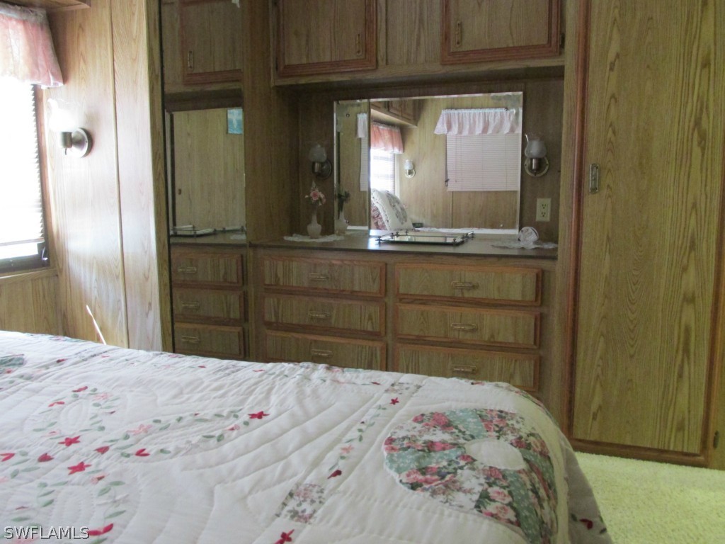 19681 Summerlin Road, Unit 208 Fort Myers, FL 33908 - Photo 2 of 3 a bedroom with a bed and a dresser